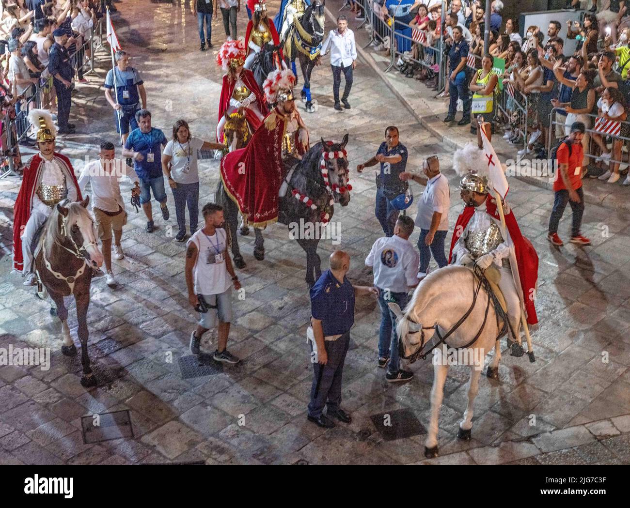 Procession for the celebration of the festival of the Brown Madonna of Matera with men on horseback in traditional garb leading the festivities Stock Photo