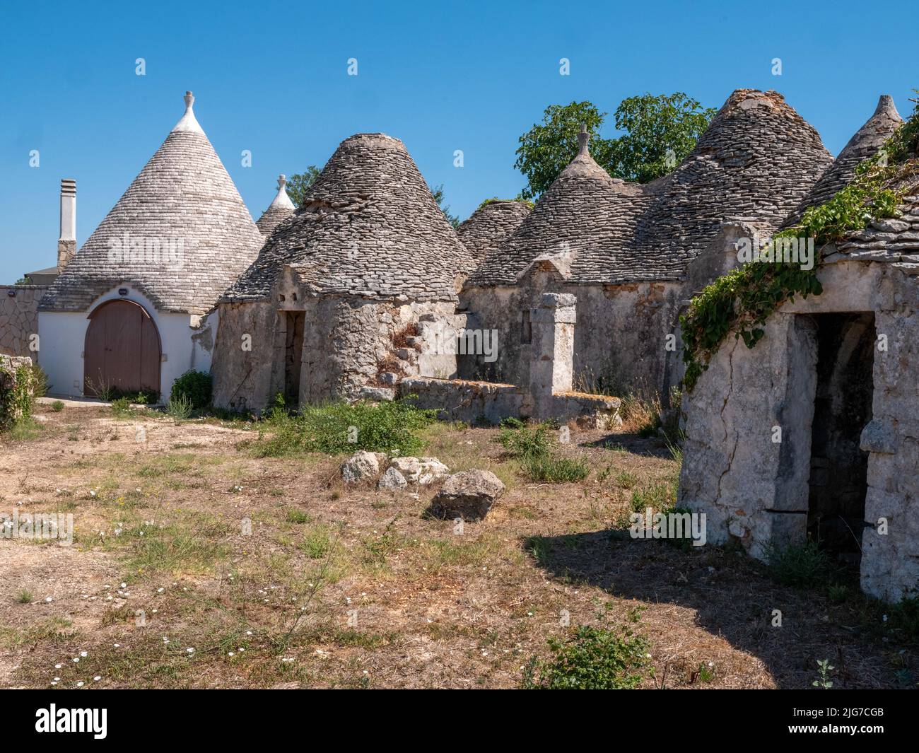 Trulli houses of Alberobello region of Puglia with conical roofs originating in prehistoric times made of limestone boulders and mortarless Stock Photo