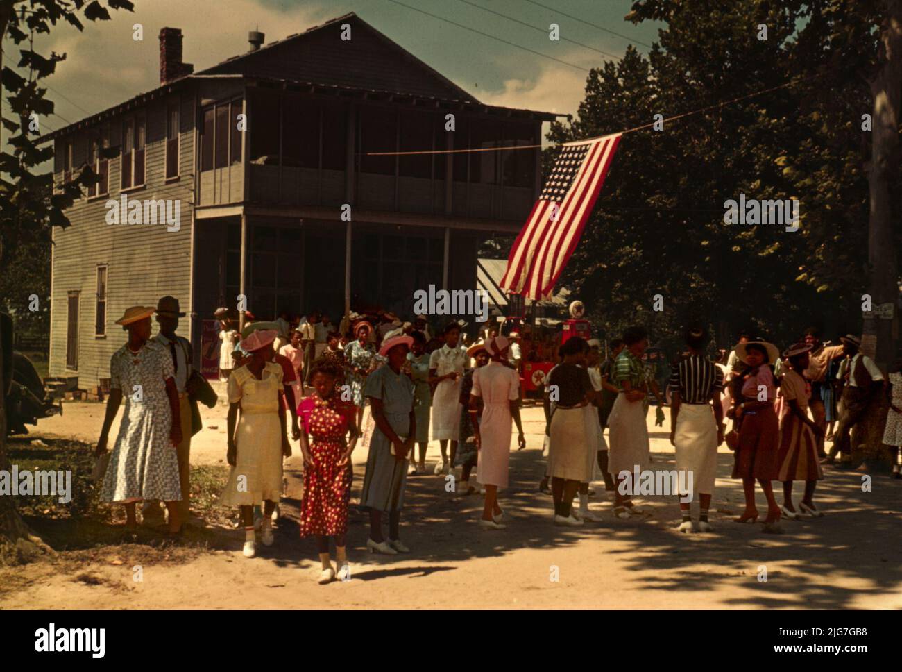 A Fourth of July celebration, St. Helena Island, S.C; shows Texaco filling station behind flag. Stock Photo