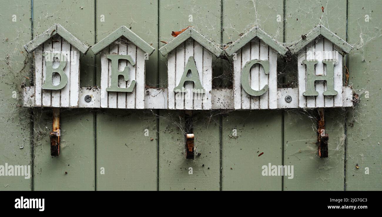 A weathered sign with the word beach on it Stock Photo