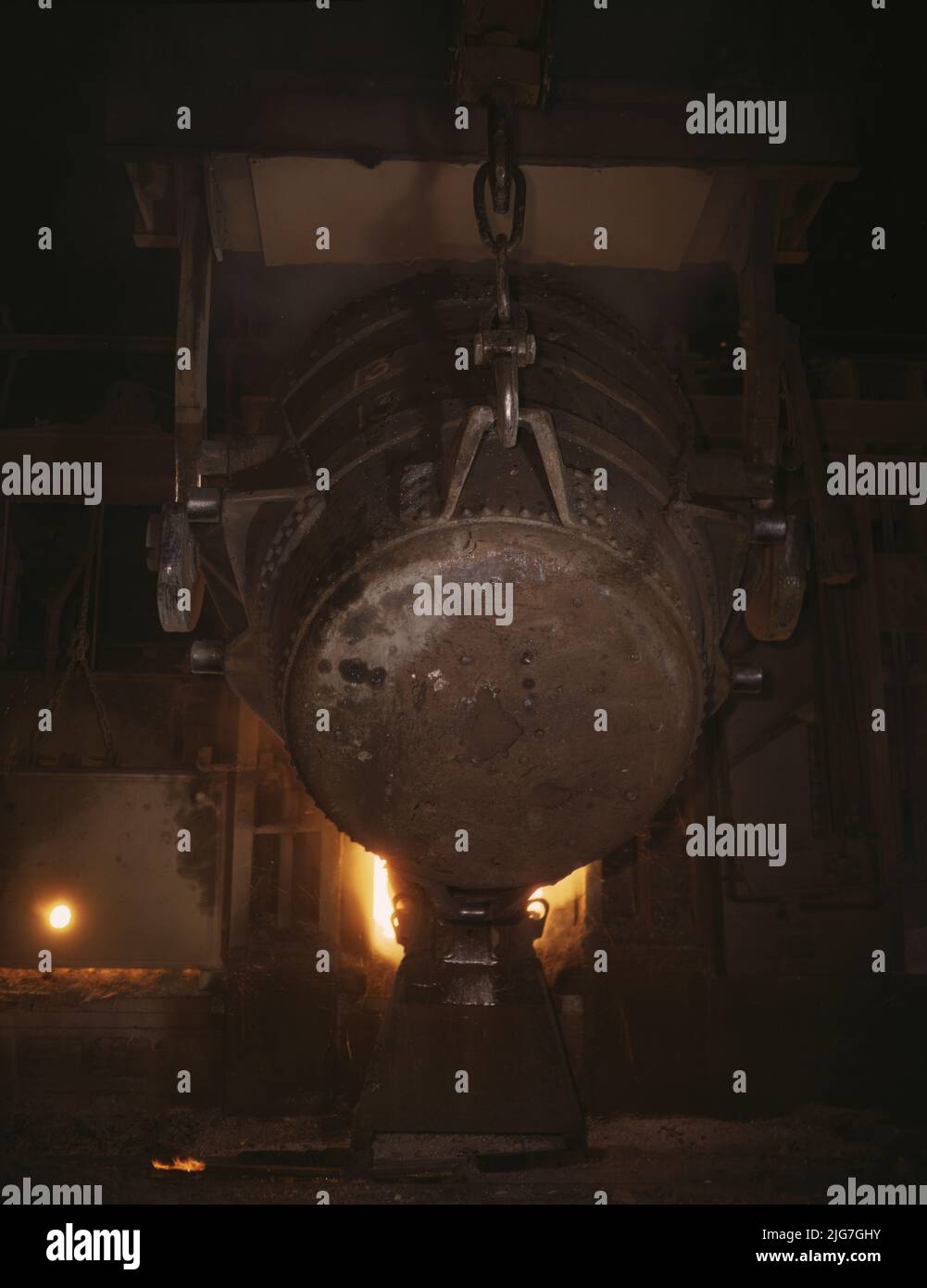 Ladle of molten iron is poured into an open hearth furnace for