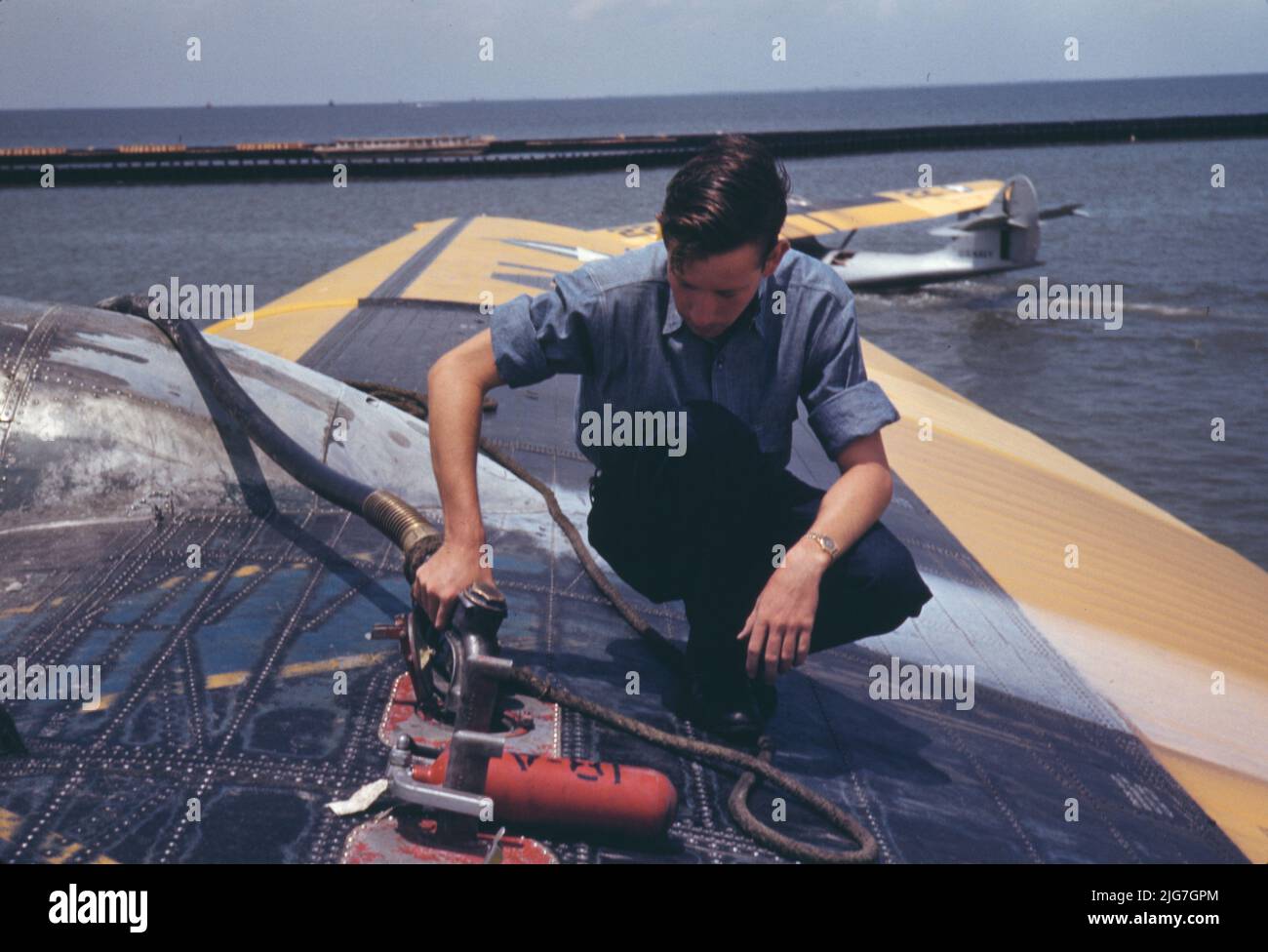 A sailor mechanic refueling a plane at the Naval Air Base, Corpus Christi, Texas. Stock Photo
