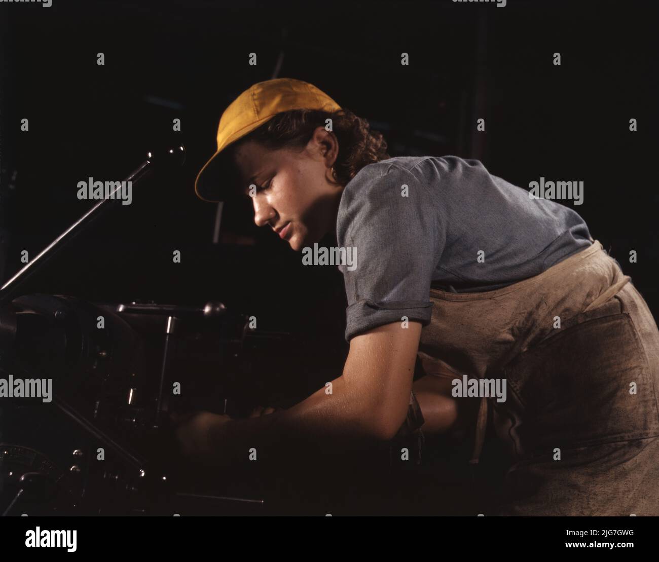 A lathe operator machining parts for transport planes at the