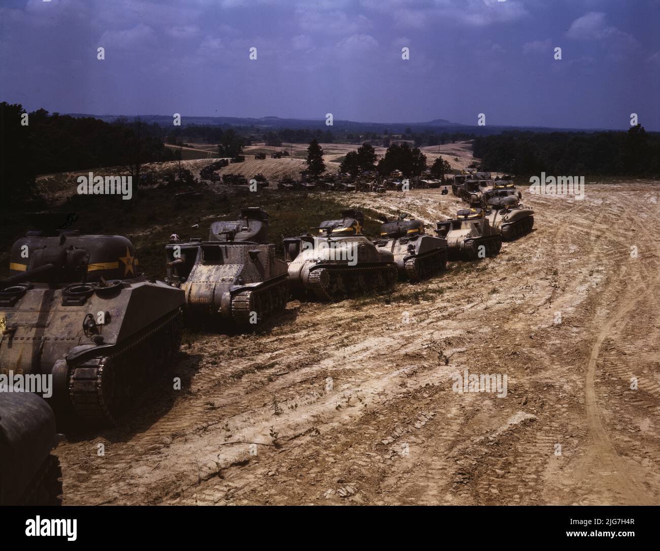 Parade of M-4 (General Sherman) and M-3 (General Grant) tanks in training maneuvers, Ft. Knox, Ky. Note the lower design of the M-4, the larger gun in the turret and the two hatches in front of the turret. Stock Photo