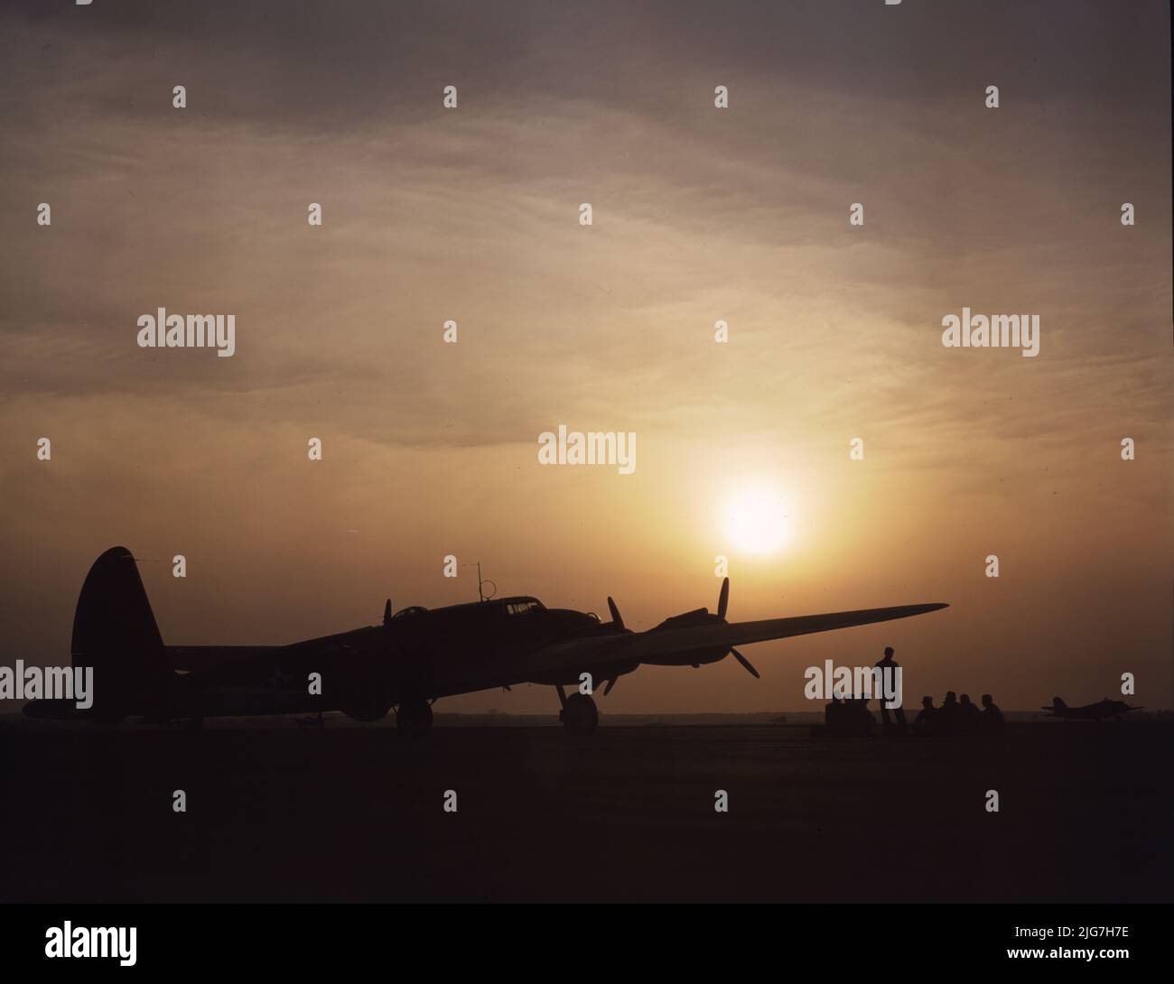 Sunset silhouette of flying fortress, Langley Field, Va. Photograph shows a B-17 bomber. Stock Photo