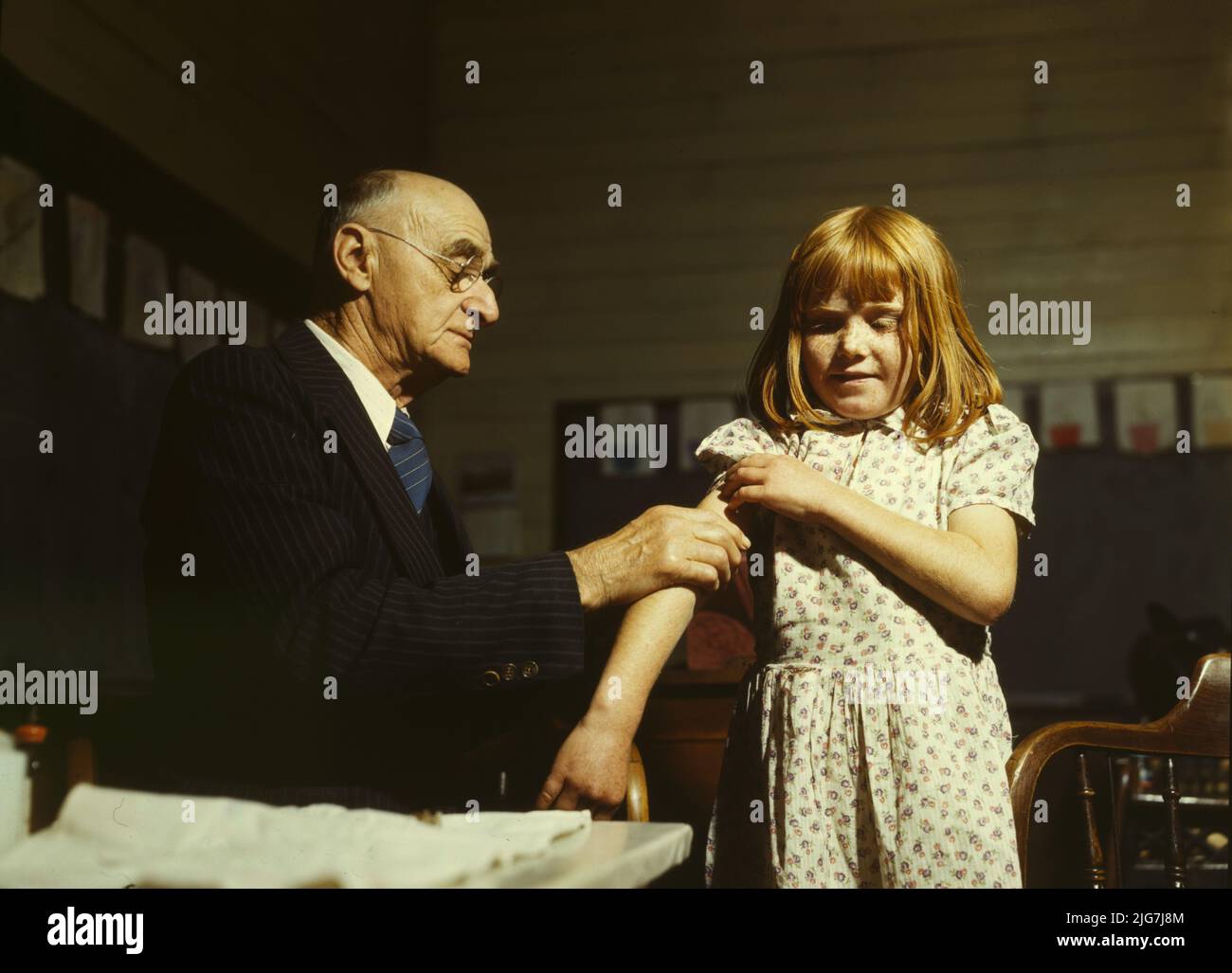 Dr. Schreiber of San Augustine giving a typhoid innoculation at a rural school, San Augustine County, Texas. Stock Photo