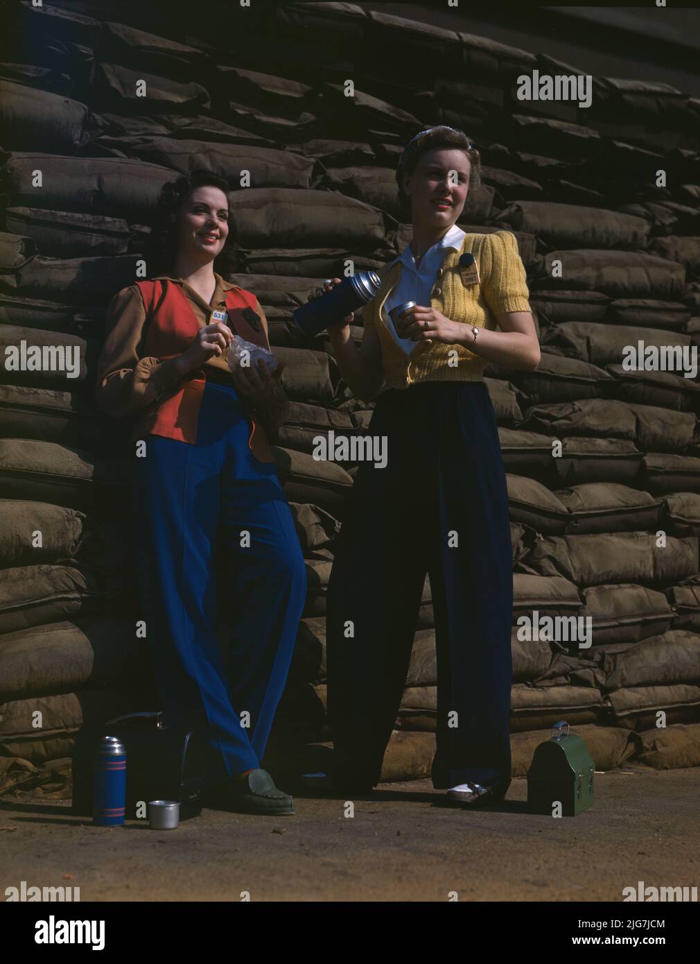 Lunchtime brings a few minutes of rest for these women workers of the assembly line at Douglas Aircraft Company's plant, Long Beach, Calif. Sand bags for protection against air raid form the background. Most important of the many types of aircraft made at this plant are the B-17F (&quot;Flying Fortress&quot;) heavy bomber, the A-20 (&quot;Havoc&quot;) assault bomber, and the C-47 heavy transport plane for the carrying of troops and cargo. Stock Photo