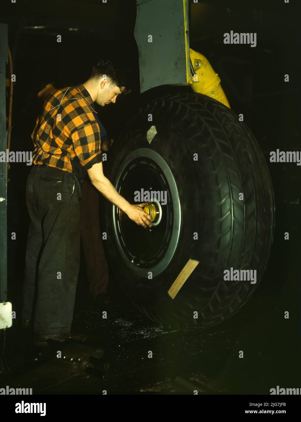 Inspecting of landing wheel of the transport planes at Willow Run