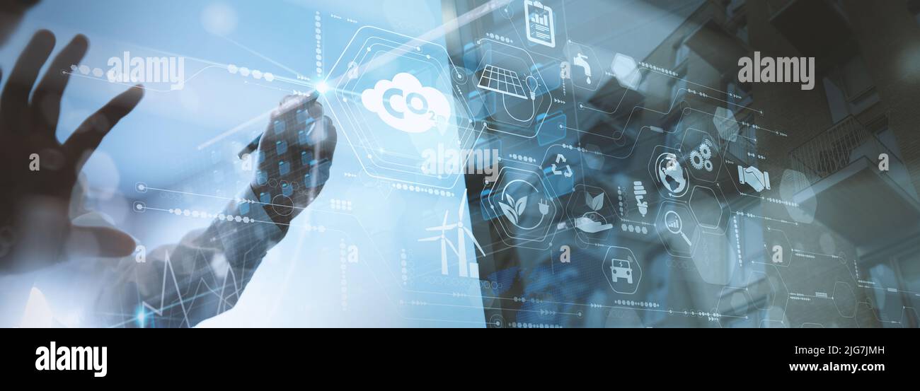 Businessman working virtual modern computer to reduce CO2 emissions ...