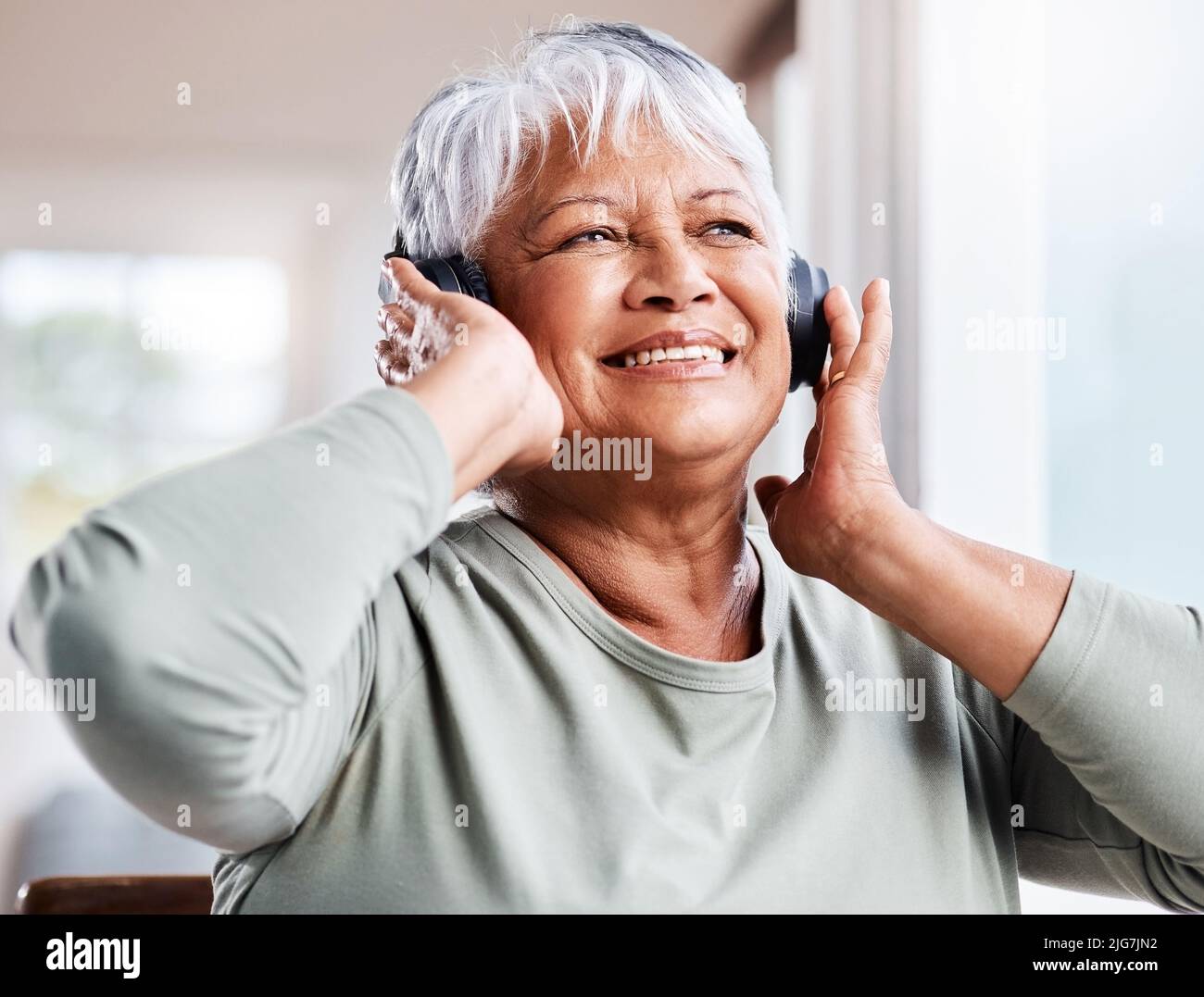My soul can still dance. Shot of a beautiful senior woman listening to