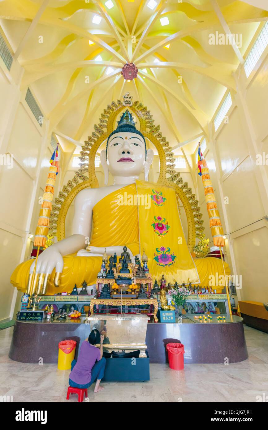 Giant Buddha in the Sakya Muni Buddha Gaya Temple, Republic of Singapore.  The temple is also known as the Temple of 1000 Lights Stock Photo