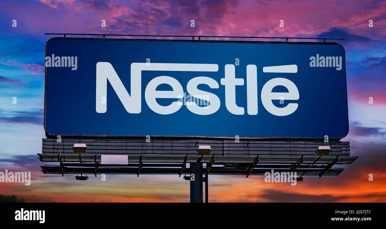 POZNAN, POL - JUN 23, 2022: Advertisement billboard displaying logo of Nestle, a multinational food and drink processing conglomerate corporation head Stock Photo