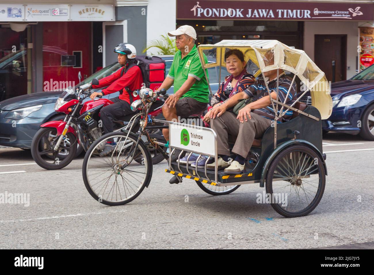 Trishaw ride, Republic of Singapore.  Trishaw Uncle is the name of a company authorized to offer rides in SIngapore.  The term Uncle is also an affect Stock Photo