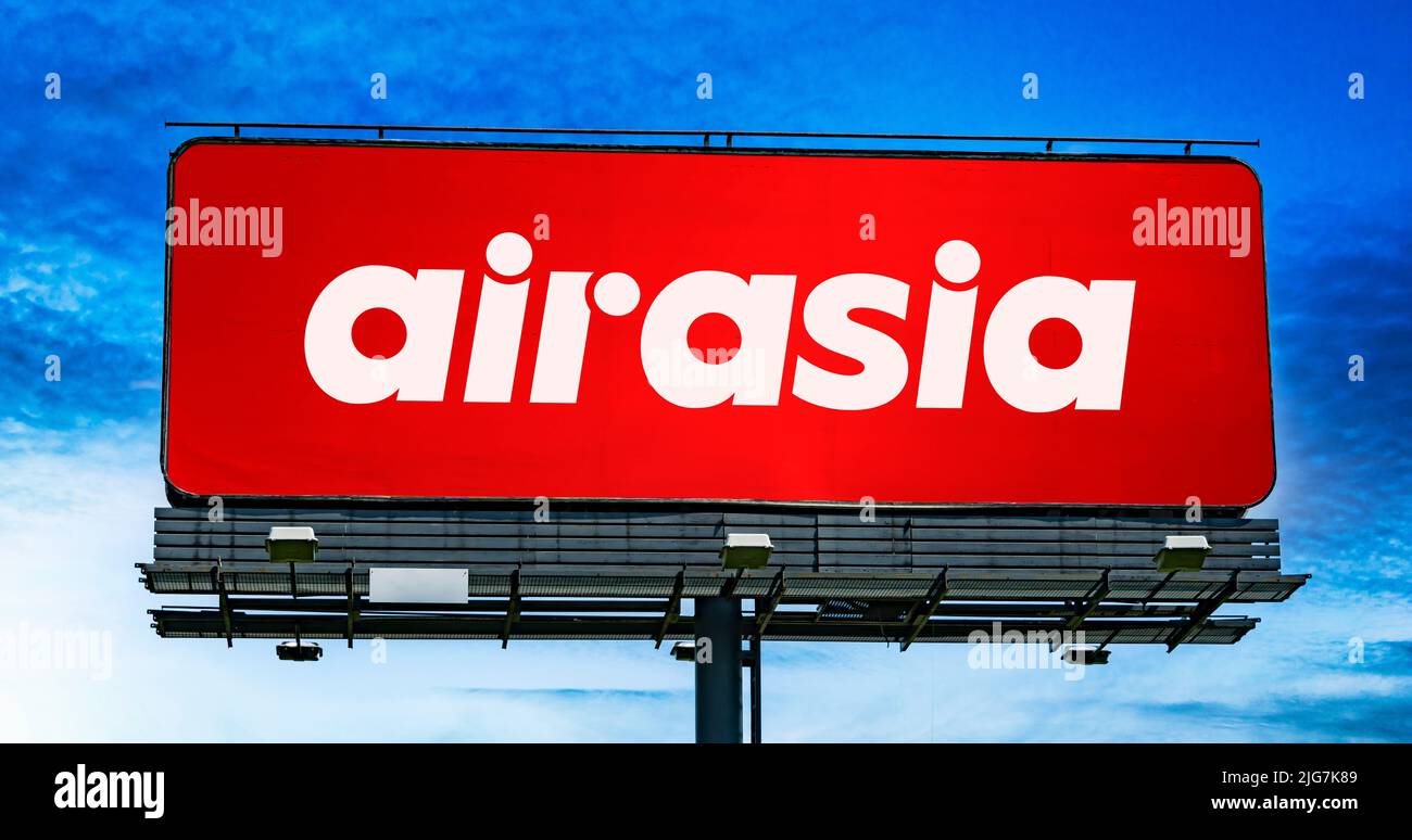 POZNAN, POL - JUN 23, 2022: Advertisement billboard displaying logo of AirAsia, a Malaysian multinational low-cost airline headquartered near Kuala Lu Stock Photo