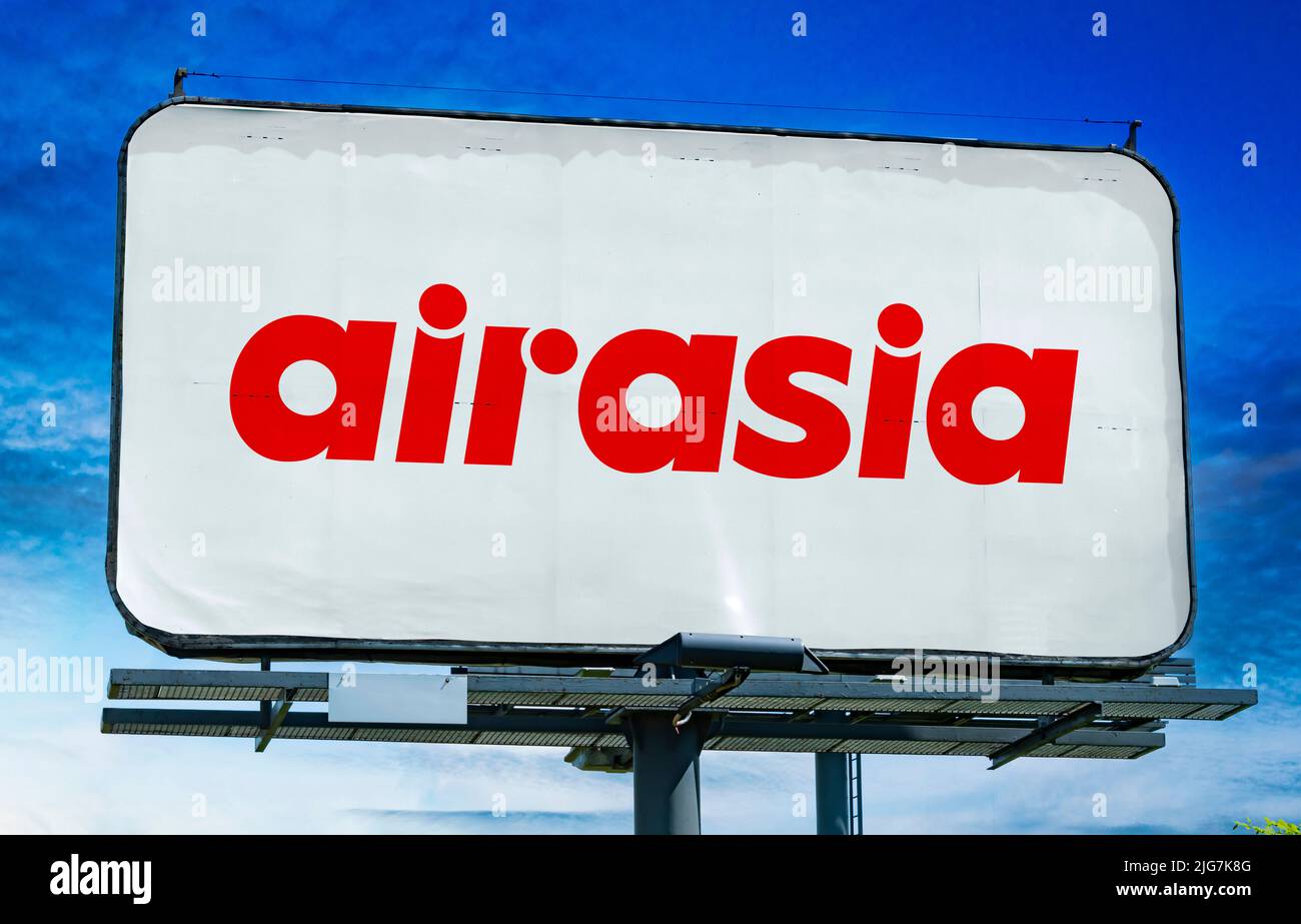 POZNAN, POL - JUN 23, 2022: Advertisement billboard displaying logo of AirAsia, a Malaysian multinational low-cost airline headquartered near Kuala Lu Stock Photo