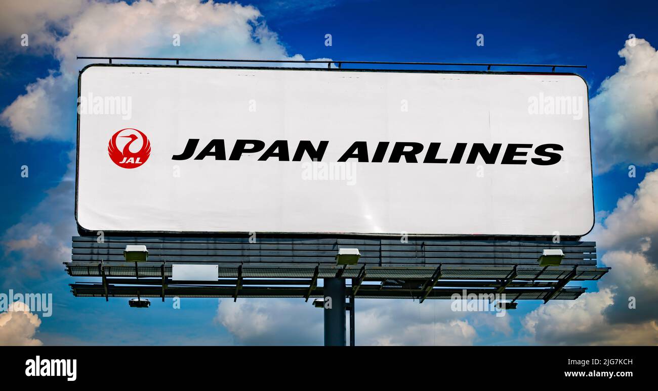 POZNAN, POL - JUN 23, 2022: Advertisement billboard displaying logo of Japan Airlines, an international airline and Japan's flag carrier, headquartere Stock Photo