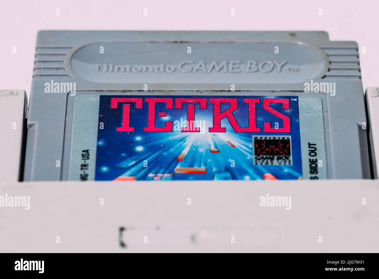 Game Boy is an 8-bit handheld game console developed and manufactured by Nintendo first released in 1989 - close up of Tetris cartridge Stock Photo