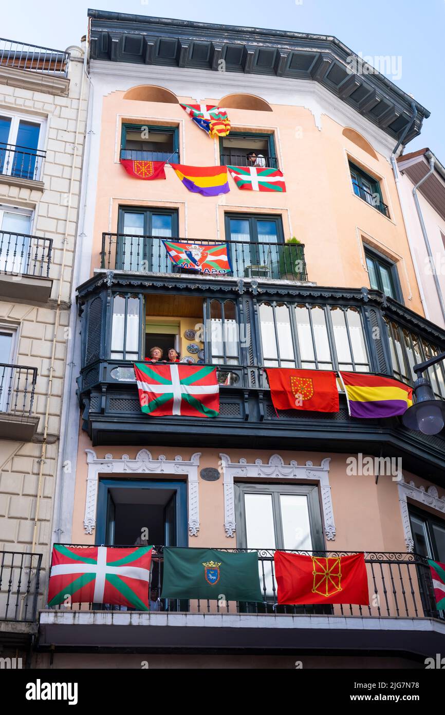 house facade with balconies and flags on the day of San Fermin. July 07, 2022. High Street. Pamplona, Navarra, Spain, Europe. Stock Photo