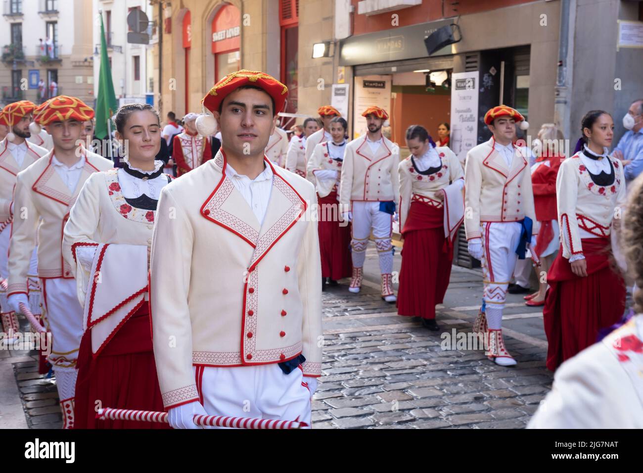 Young people in uniform in the traditional procession of the day of San Fermin. July 07 2022. Pamplona, Navarre, Spain, Europe Stock Photo