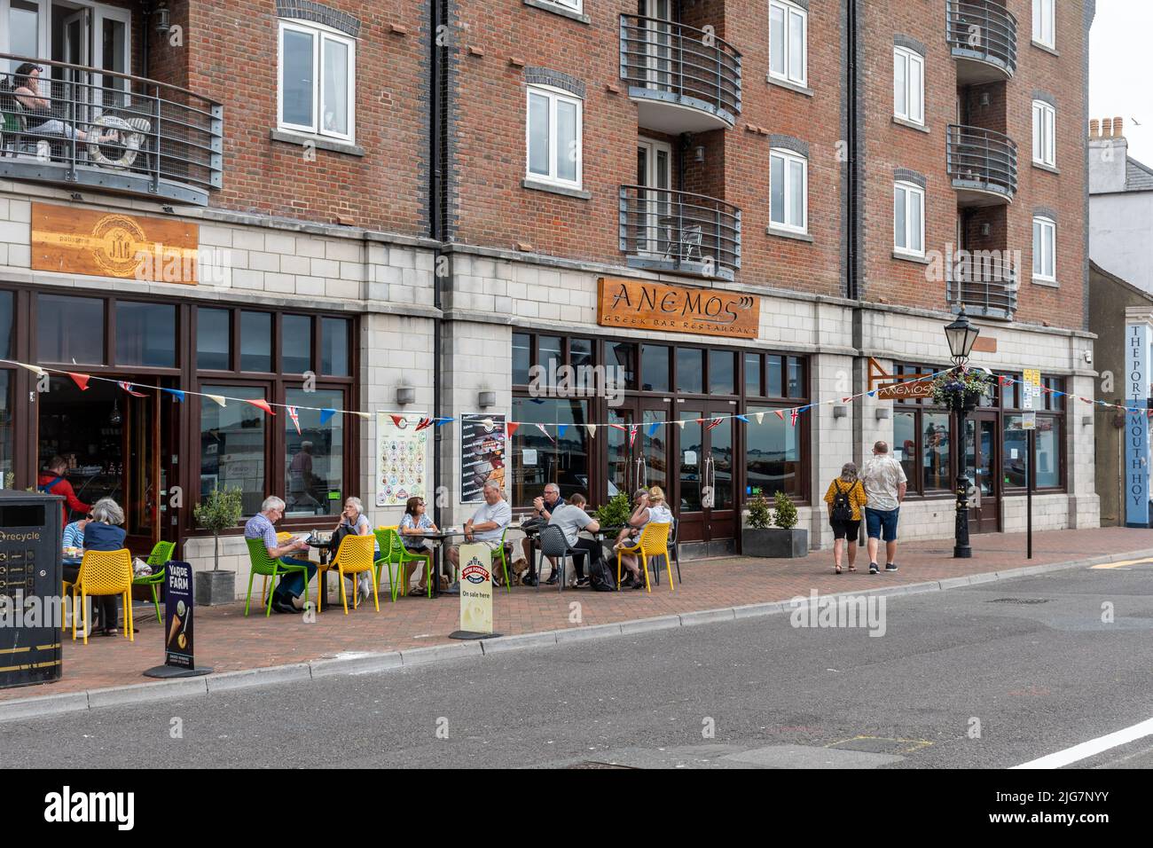 Alfresco dining outside ice cream parlour and Greek restaurant on Poole Quay, Poole, Dorset, England, UK Stock Photo