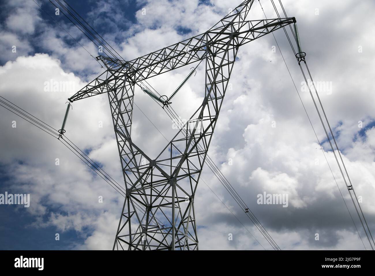 High voltage electric pole against blue sky background Stock Photo - Alamy