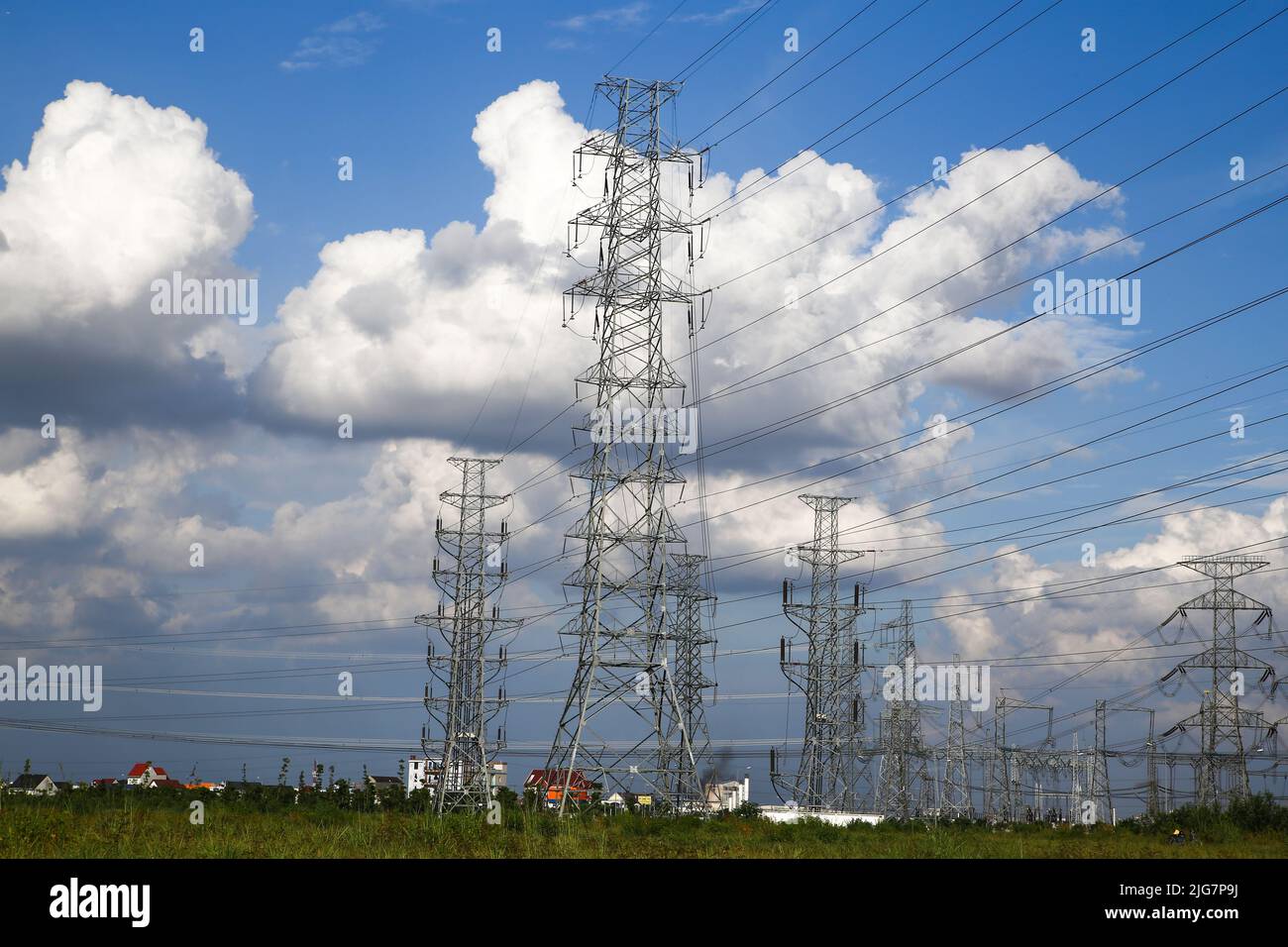 High voltage electric pole against blue sky background Stock Photo - Alamy