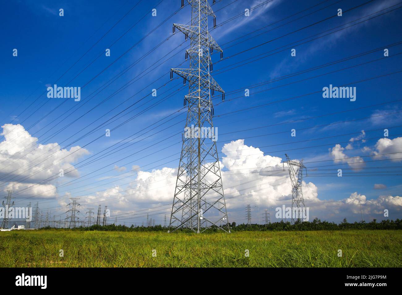 High voltage electric pole against blue sky background Stock Photo - Alamy
