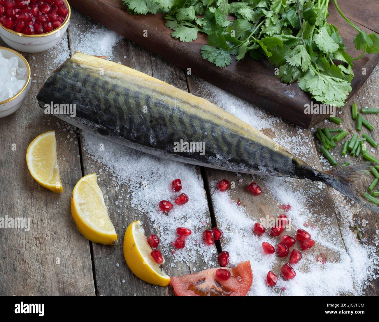 A process of preparing a fish dish with various ingredients Stock Photo
