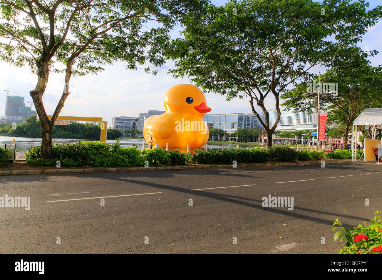 Giant 'Rubber Duck' sculpture by artist Florentijn Hofman swims in Phu My Hung, Vietnam. Local residents and tourists are drawn to the attraction. Stock Photo
