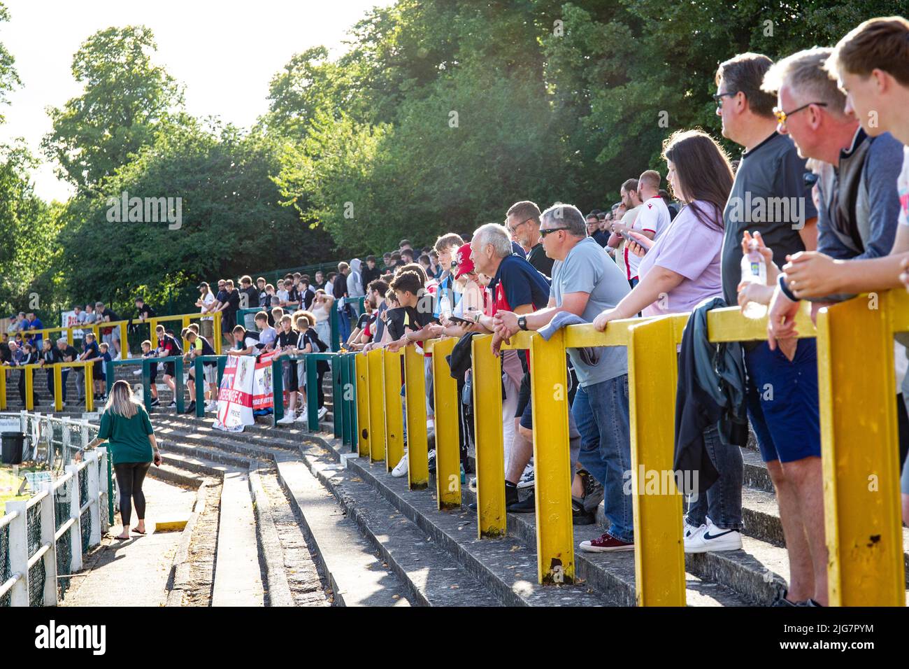 Football spectators watching match from stand at non league football ground in England Stock Photo