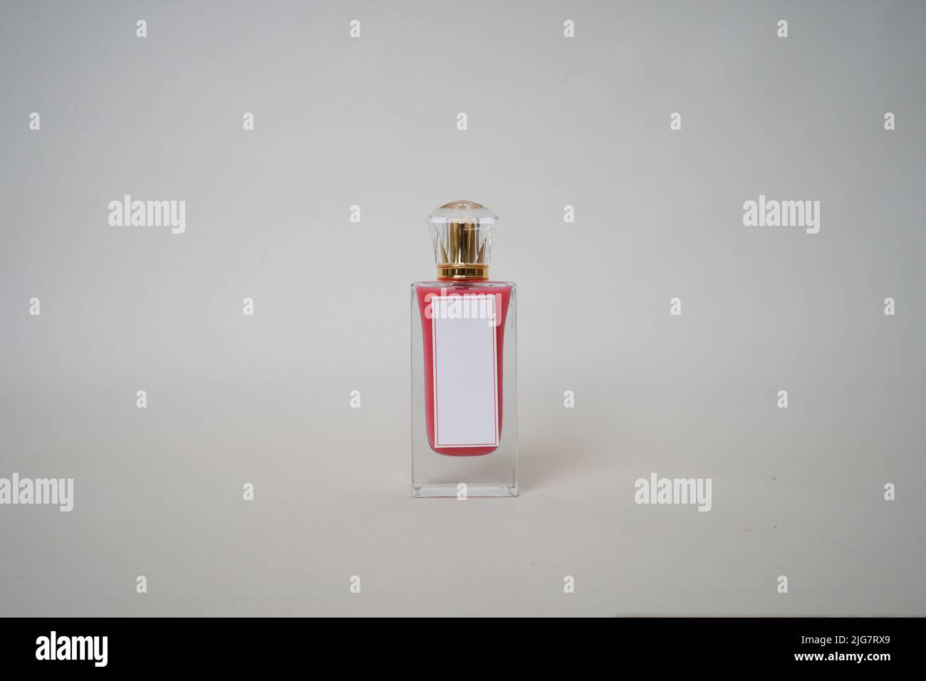 Red Perfume bottle and cap for branding isolated on white background, Red Perfume bottle mockup. Stock Photo