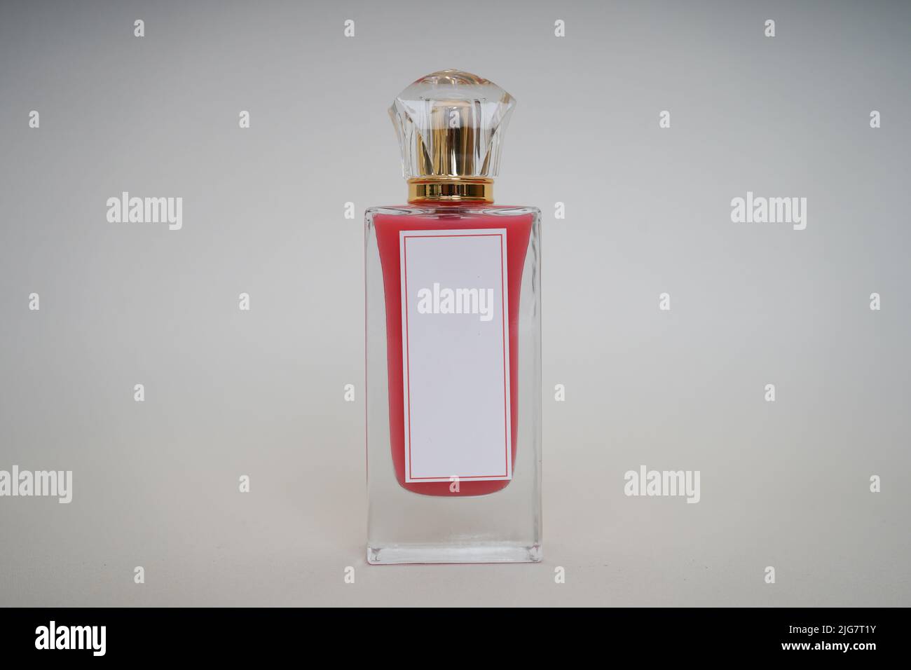 Red Perfume bottle and cap for branding isolated on white background, Red Perfume bottle mockup. Stock Photo