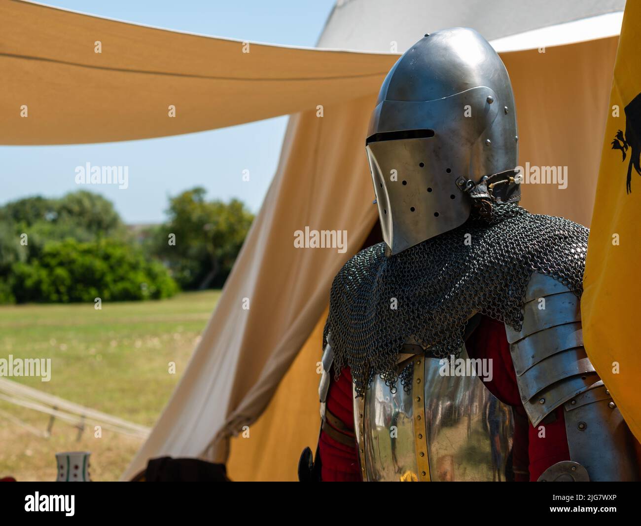 outside a camp tent of a medieval knight plate armor on a mannequin
