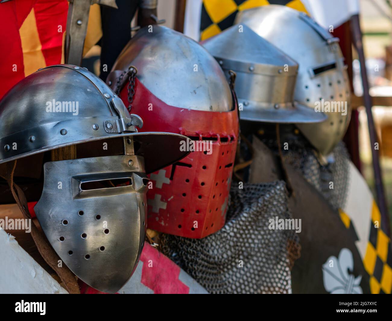 display of various types of medieval plate armor helmets Stock Photo
