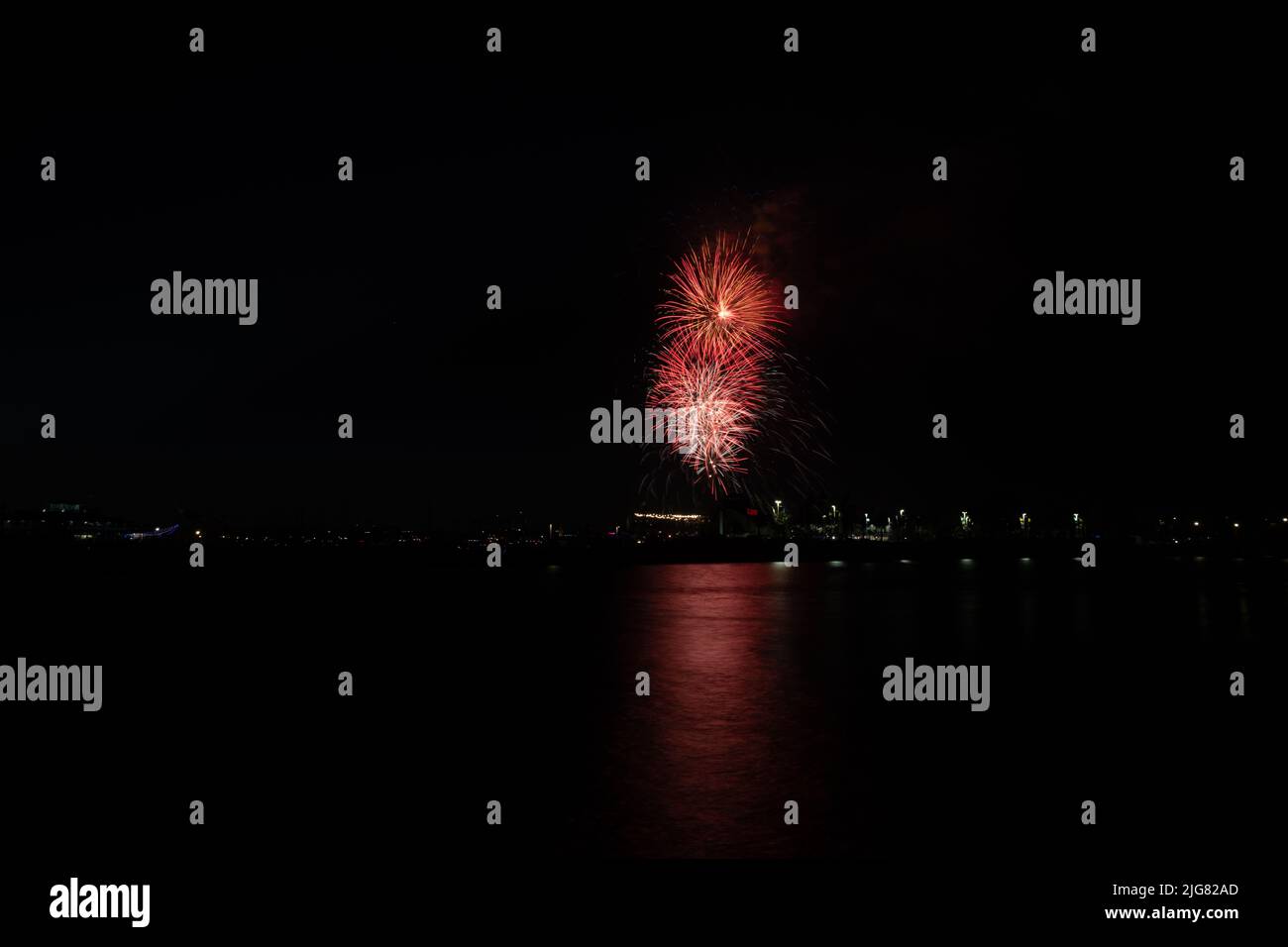 Fireworks shoot off over water of Alamitos Bay in Long Beach, CA to