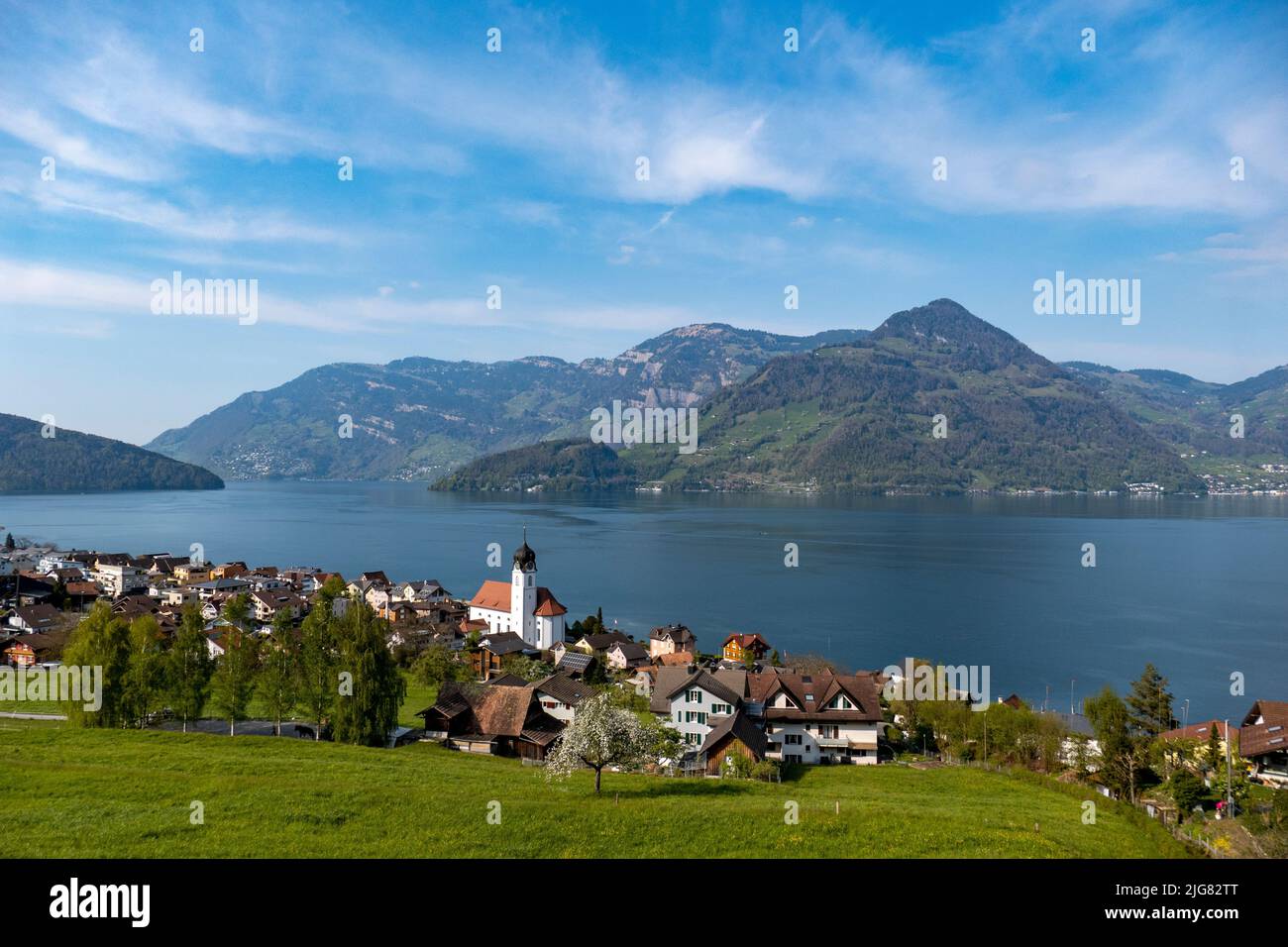 The Beckenried Church by Lake Lucerne with the Alps in the background from the distance Stock Photo