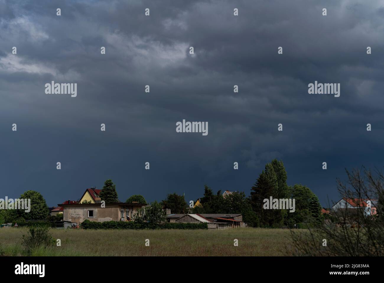 Large rain clouds over a small village just before a bad storm Stock Photo