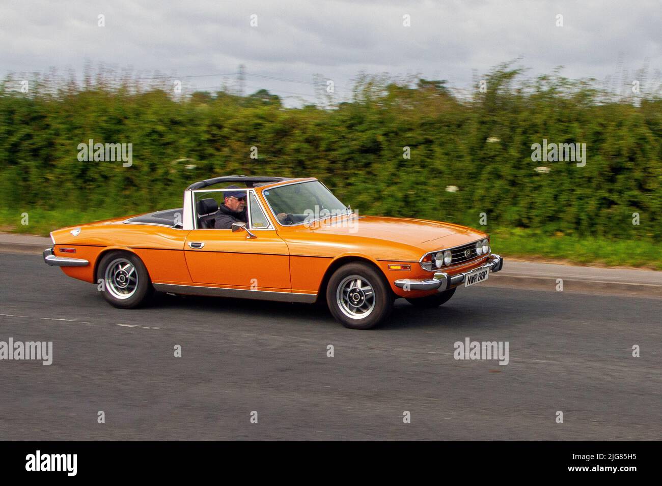 1975 seventies 70s orange Triumph Stag 2997cc en route to Hoghton Tower for the Supercar Summer Showtime car meet which is organized by Great British Motor Shows in Preston, UK Stock Photo