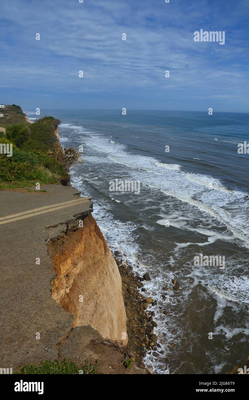 A vertical view of the street road on the cliff ending by the ocean