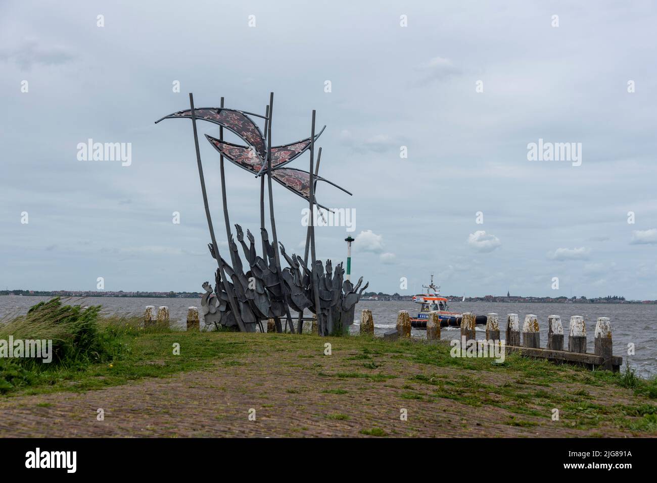 Monument The Wave, commemorating the flood of 1916, created by artist Linda Verkaaik, Marken Island, Noord-Holland, Netherlands. Stock Photo