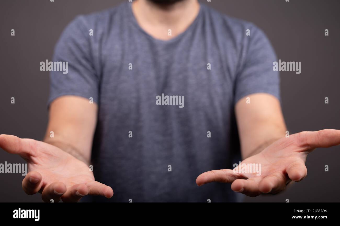 A closeup shot of a young guy opening his hands Stock Photo