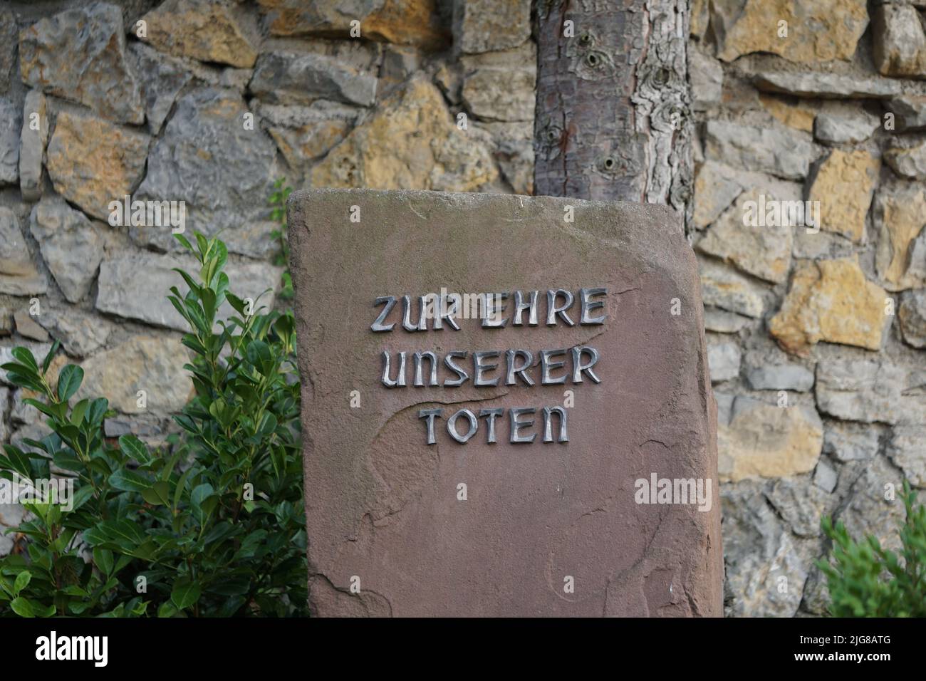 A stone plaque inscribed on it Zur Ehre unserer Toten in Karlsdorf Neuthard, Germany Stock Photo