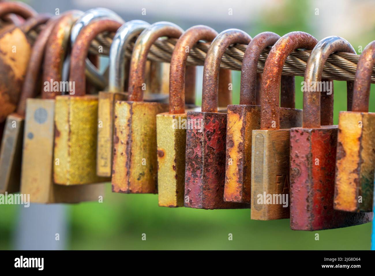 Love locks hang on the chain bridge in Bamberg Stock Photo