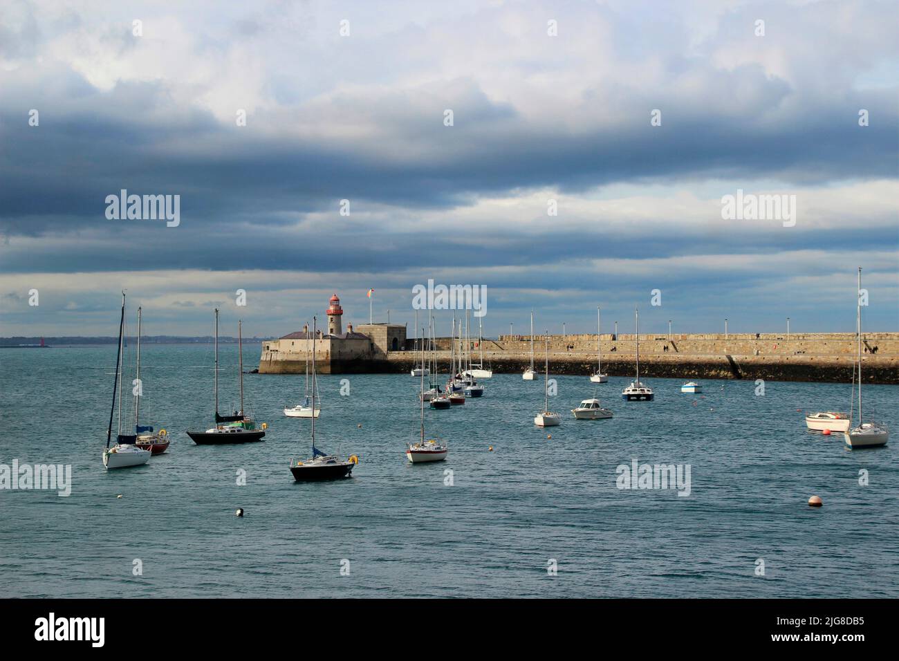 View of lighthouse, boats in Dun Laoghaire, county Dublin, Ireland, thunderstorm atmosphere Stock Photo