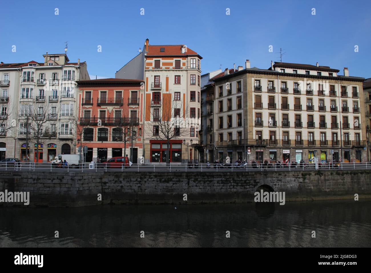 The view of the colorful city buildings at the riverbank in Bilbao ...