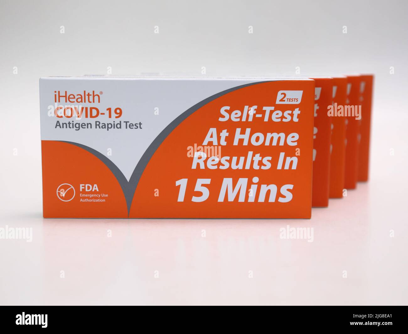 USA - July 8, 2022: Five new boxes containing iHealth brand COVID-19 antigen rapid tests are shown isolated against a white background. Stock Photo
