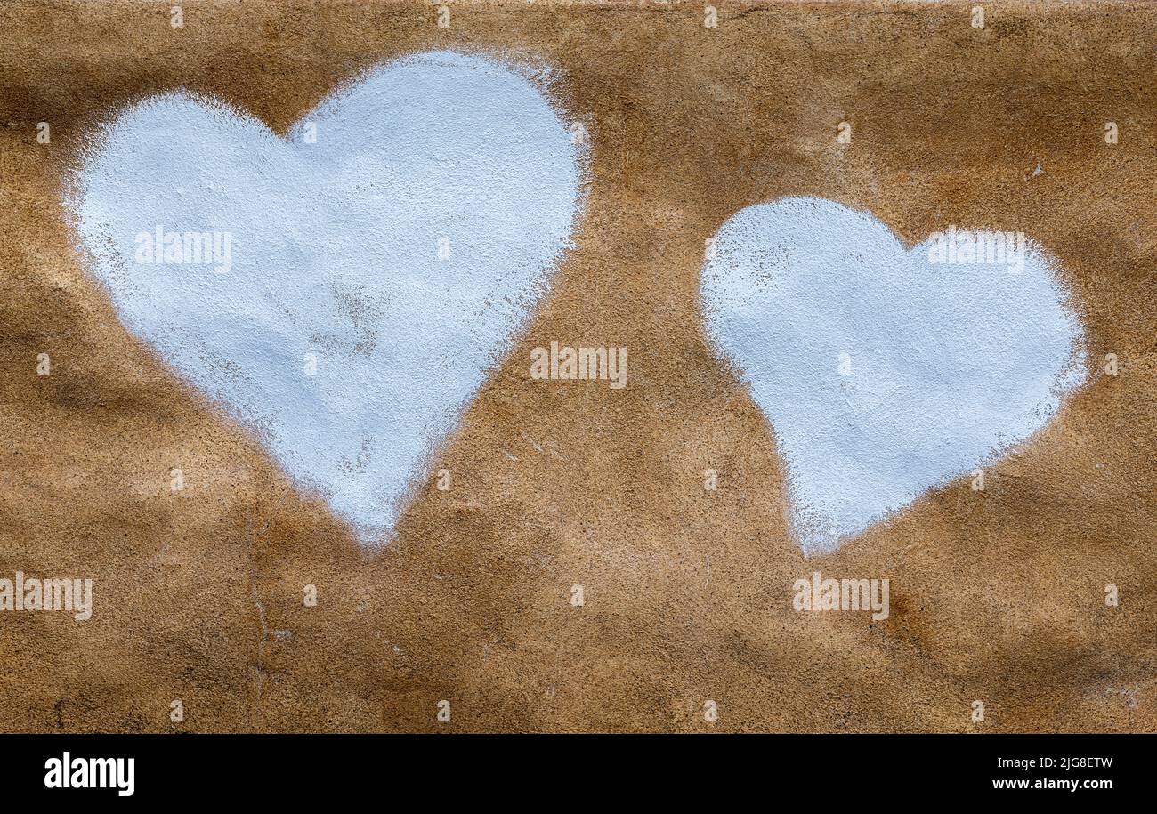 Two white hearts painted on a wall Stock Photo