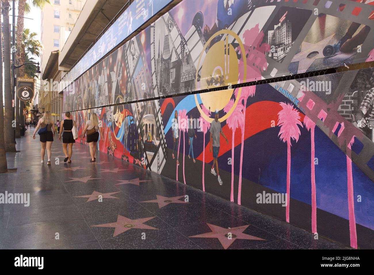 A artistic mural next to the Hollywood Walk of Fame covered with the