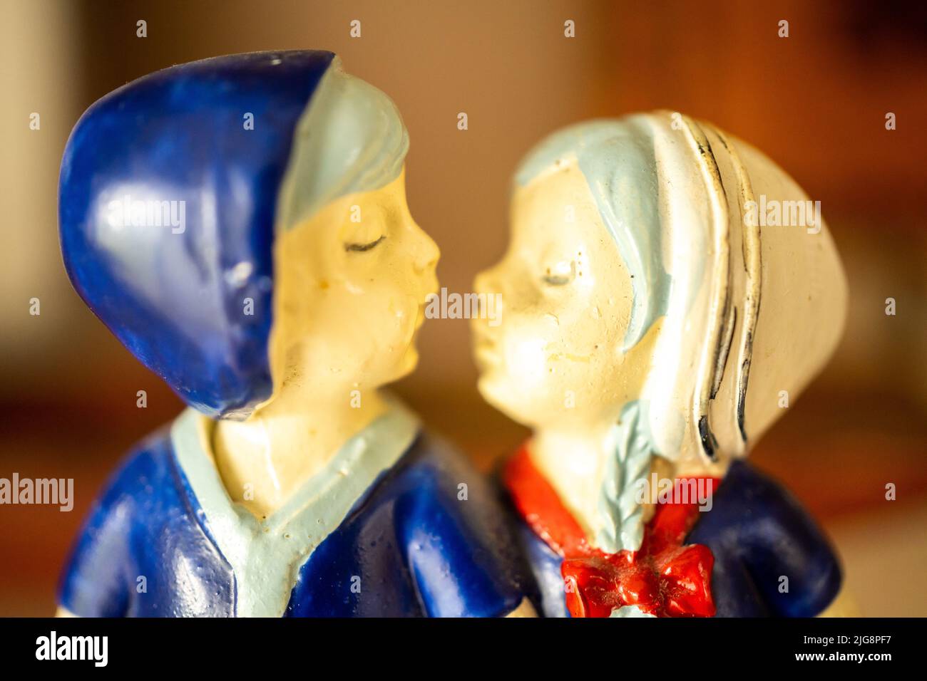 The closeup shot of a Dutch kissing couple ceramic figurine souvenir