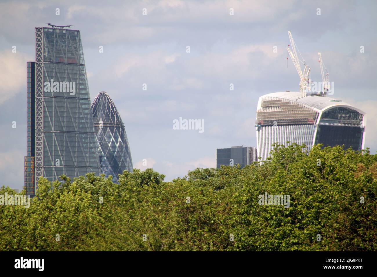 The modern buildings behind the trees in London Stock Photo